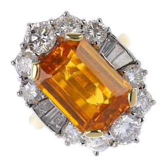 An 18ct gold sapphire and diamond cluster ring. The rectangular-shape orange sapphire, within a grad