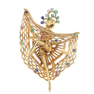 A 1950s diamond and gem-set can-can dancer clip. The female figure, raising her sapphire, ruby and e
