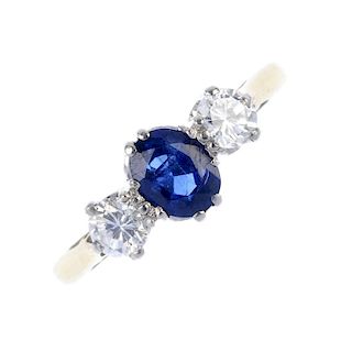 A sapphire and diamond three-stone ring. The oval-shape sapphire, to the brilliant-cut diamond shoul