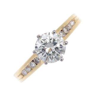 A diamond single-stone ring. The brilliant-cut diamond, raised to the graduated similarly-cut diamon