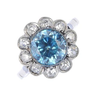 A zircon and diamond cluster ring. The circular-shape blue zircon, within an old-cut diamond scallop