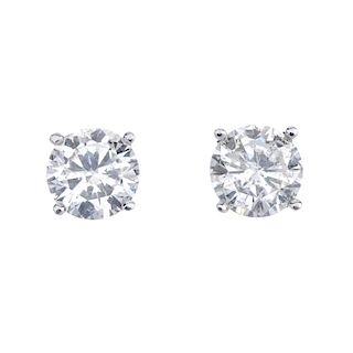 A pair of brilliant-cut diamond single-stone ear studs. Estimated total diamond weight 1.35cts, I-J