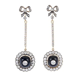 A pair of diamond and onyx ear pendants. Each designed as a cushion-shape onyx cabochon and old-cut