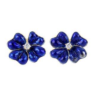 A pair of diamond and enamel floral ear studs. Each designed as a blue enamel flower, with brilliant