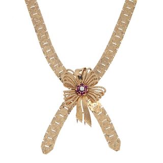 A 1960s 9ct gold diamond and ruby collar. The detachable rope-twist bow, with brilliant-cut diamond