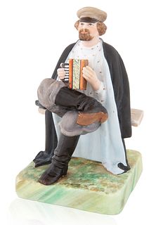 A RUSSIAN PORCELAIN FIGURINE OF AN ACCORDION PLAYER, GARDNER PORCELAIN FACTORY, VERBILKIN, MOSCOW, 1870-1890