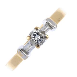 An 18ct gold diamond ring. Of bi-colour design, the brilliant-cut diamond, with baguette-cut diamond