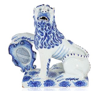 A DELFT STYLE BLUE AND WHITE CHINOISERIE MODEL OF A LION, 19TH CENTURY 