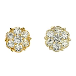 A pair of coloured diamond floral cluster ear studs. The brilliant-cut 'yellow' diamond, within a si