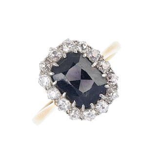 An 18ct gold colour-change sapphire and diamond cluster ring. The cushion-shape colour-change sapphi
