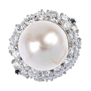 A cultured pearl and diamond cluster ring. The cultured pearl, measuring 20mms, within a brilliant-c