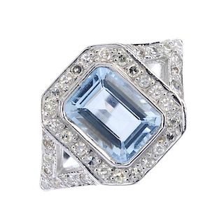 An aquamarine and diamond dress ring. The rectangular-shape aquamarine, within a single-cut diamond