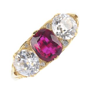 A ruby and diamond three-stone ring. The rectangular-shape ruby and old-cut diamond line, with diamo