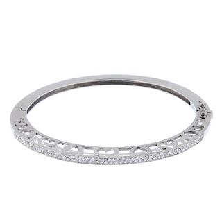 A diamond hinged bangle. The front designed as two brilliant-cut diamond lines, to the heart-shape s
