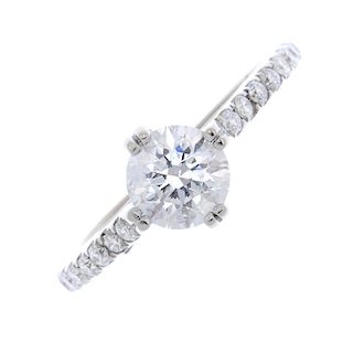 An 18ct gold diamond single-stone ring. The brilliant-cut diamond, to the brilliant-cut diamond shou