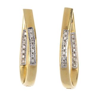 A pair of diamond ear hoops. Each design as an elongated hinged hoop, with single-cut diamond line h