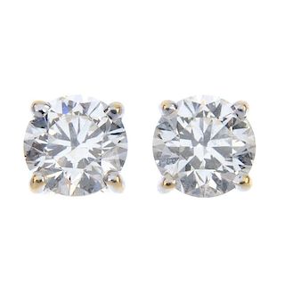 A pair of brilliant-cut diamond single-stone ear studs. Estimated total diamond weight 1ct, I-J colo