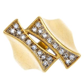 An 18ct gold diamond dress ring. Of asymmetric design, the staggered tapered panels, set with single