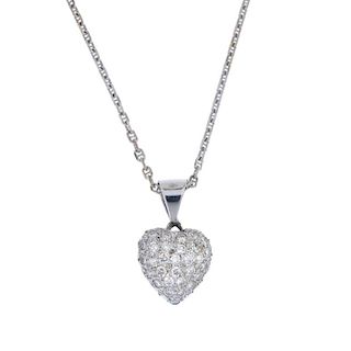 A diamond heart pendant. The pave-set brilliant-cut diamond heart, to the tapered surmount, suspende