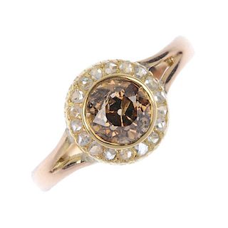 A coloured diamond and diamond cluster ring. The old-cut 'brown' diamond, within a rose-cut diamond