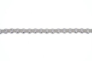 An 18ct gold diamond bracelet. Designed as a series of pave-set diamond links, with curved-link spac
