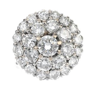 A diamond cluster ring. The brilliant-cut diamond stepped cluster, to the tapered sides and plain ba