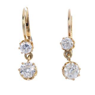 A pair of diamond ear pendants. Each designed as an old-cut diamond, suspended from a similarly-cut