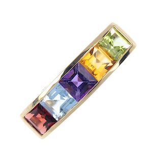 An 18ct gold multi-gem five stone ring. The square-shape garnet, blue topaz, amethyst, citrine, and