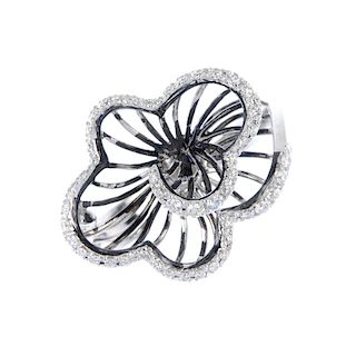 An 18ct gold diamond floral ring. Of wirework design, the graduated brilliant-cut diamond scalloped