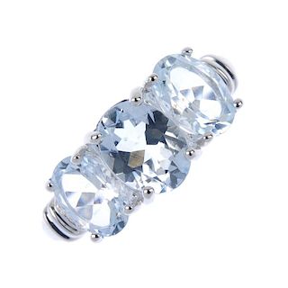 An 18ct gold aquamarine and diamond ring. The oval-shape aquamarine line, with single-cut diamond an