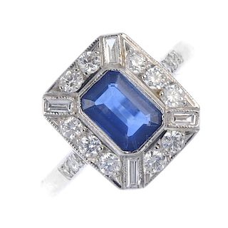 A sapphire and diamond cluster ring. The rectangular-shape sapphire, within a rectangular-shape and