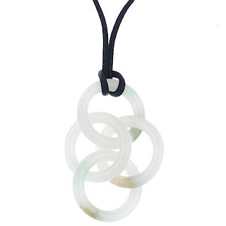 A jade pendant. Designed as a series of four interlocking nephrite jade hoops, to the black fabric c