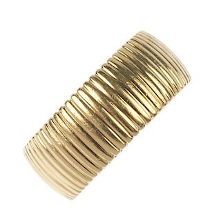 ANDREW GEOGHEGAN - an 18ct gold ring. Designed as a series of ridges, to the wide band. Maker's mark