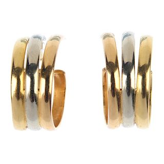 CARTIER - a pair of ear hoops. Each designed as three tri-colour curved bars. Signed and numbered Ca