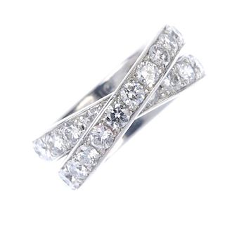 CARTIER - a diamond 'Paris Nouvelle Vague' ring. Comprising two brilliant-cut diamond crossover line