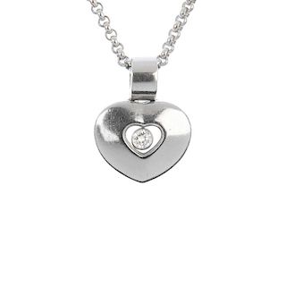 CHOPARD - a 'Happy Diamonds' heart pendant. The brilliant-cut diamond collet, suspended within a hea