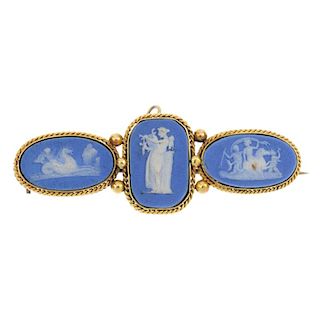 WEDGWOOD - a late 19th century cameo brooch. The three oval blue and white jasperware cameos, each d