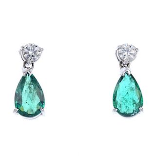* A pair of emerald and diamond ear pendants. Each designed as a pear-shape emerald, suspended from