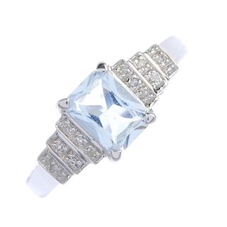 An 18ct gold aquamarine and diamond ring. The rectangular-shape aquamarine, to the single-cut diamon
