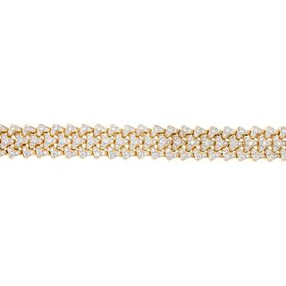 An 18ct gold diamond articulated bracelet. Comprising three rows of pave-set diamond chevron links.