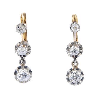 A pair of diamond ear pendants. Each designed as an old-cut diamond within a scalloped surround, sus