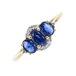 An 18ct gold sapphire and diamond three-stone ring. The slightly graduated oval-shape sapphire line,