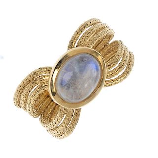 An 18ct gold moonstone dress ring. The oval moonstone cabochon collet, to the tapered flexible rope