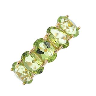 An 18ct gold peridot five-stone ring. The oval-shape peridot line, to the tapered band. Hallmarks fo