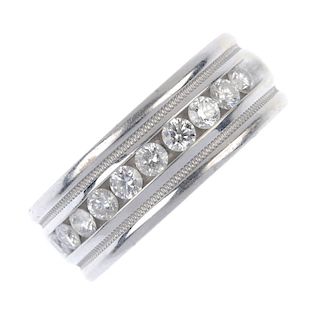 A diamond band ring. Designed as a series of ten brilliant-cut diamonds, within a channel setting, t