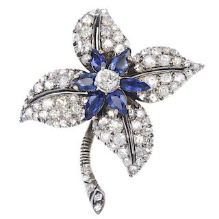 An early 20th century gold diamond and sapphire floral brooch. The old-cut diamond, within a pear-sh