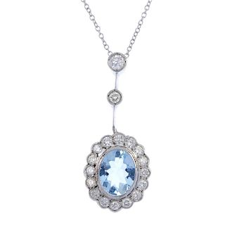 An aquamarine and diamond pendant. The oval-shape aquamarine, within a brilliant-cut diamond surroun