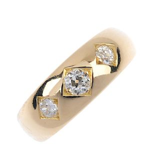 A late Victorian 18ct gold diamond three-stone ring. The graduated old-cut diamond line, inset to th