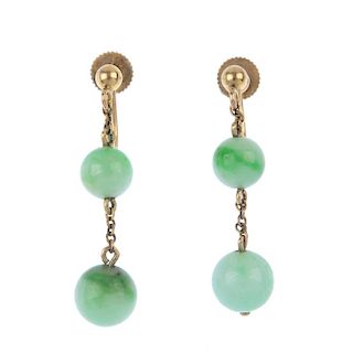 A pair of jade ear pendants. Each designed as two graduated jadeite beads, suspended along a trace-l