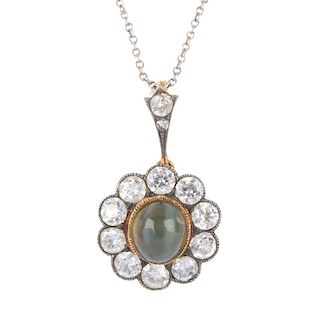 An early 20th century gold cat's-eye chrysoberyl and diamond cluster pendant. The oval cat's-eye chr